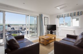 Lounge with sea views at Heron House, self catering cottage in Rock, Cornwall
